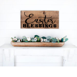 A 12x18 Easter Blessings wooden sign hangs on a white shiplap wall above a white mantel decorated with a tray of greenery and cotton stems. - Spruced Studio Upscale Workshop