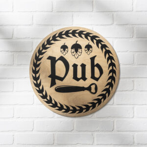 The 18 Round Pub is a round wooden sign with "Pub" in black letters, laurel wreath and hop illustrations, plus a bottle opener icon, displayed on a white brick wall. - Spruced Studio Upscale Workshop
