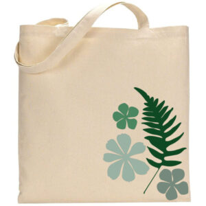 The "Ferns & Flowers" tote bag features a beige canvas with a green fern and four green floral designs printed on the front. - Spruced Studio Upscale Workshop