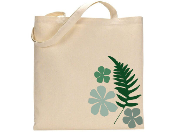The "Ferns & Flowers" tote bag features a beige canvas with a green fern and four green floral designs printed on the front. - Spruced Studio Upscale Workshop