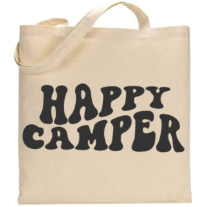 The Happy Camper tote bag features large, bold, black bubble-style letters spelling "HAPPY CAMPER" on a beige background. - Spruced Studio Upscale Workshop
