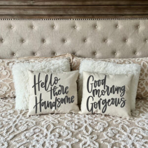 A bed with a tufted headboard, decorative pillows, and two accent pillows from the "Hello Handsome + Morning Gorgeous" set. - Spruced Studio Upscale Workshop