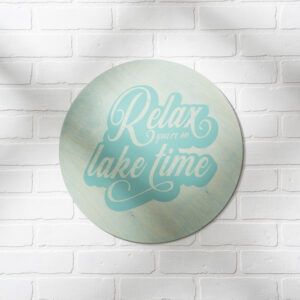 The 18 Round Lake Time sign features the phrase "Relax you're on lake time" in script font and is displayed on a white brick wall. - Spruced Studio Upscale Workshop