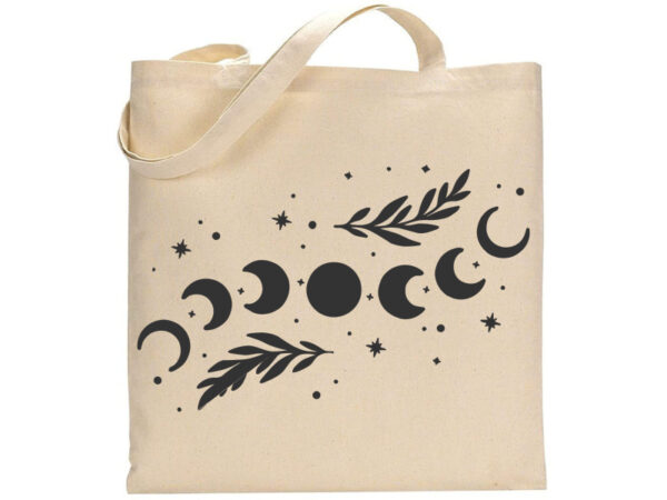 The Moon Phase tote bag features a beige color with a black graphic showing moon phases, stars, and two leafy branches. - Spruced Studio Upscale Workshop