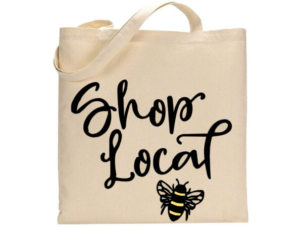 Shop Local tote bag in beige features "Shop Local" in black script and a small black and yellow bee illustration at the bottom. - Spruced Studio Upscale Workshop