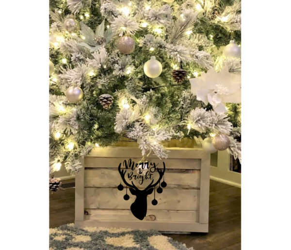 The Tree Box - Deer with Ornaments features a frosted Christmas tree with white lights and ornaments in a wooden box base, adorned with a black reindeer head and the phrase "Merry & Bright. - Spruced Studio Upscale Workshop