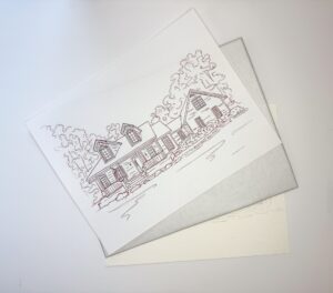 A line drawing of a house with trees in the background is placed on top of two sheets of paper on a white surface. - Spruced Studio Upscale Workshop
