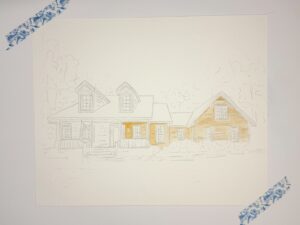A partially painted watercolor illustration of a house, with some areas filled in yellow and other sections outlined in pencil, secured to a surface with two pieces of decorative tape. - Spruced Studio Upscale Workshop