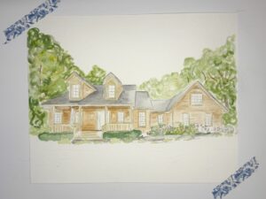 A watercolor painting of a tan house with a covered porch, dormer windows, and surrounding trees, taped to a white background with blue patterned tape. - Spruced Studio Upscale Workshop