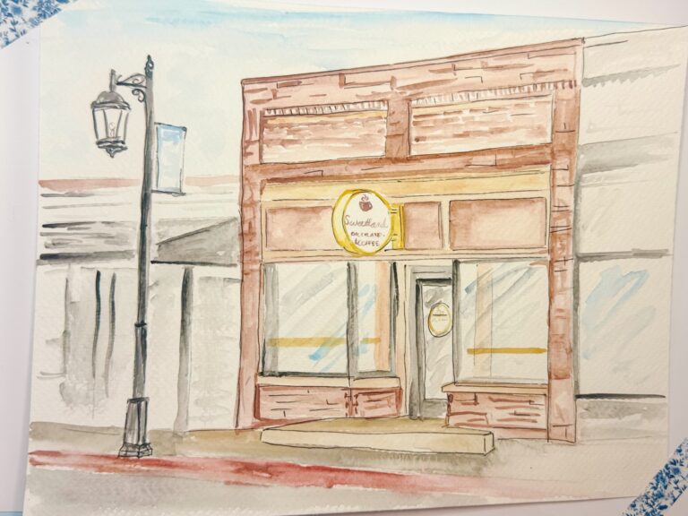 Watercolor painting of a brick storefront with large windows and a round sign above the door, next to a streetlamp on a sidewalk. - Spruced Studio Upscale Workshop
