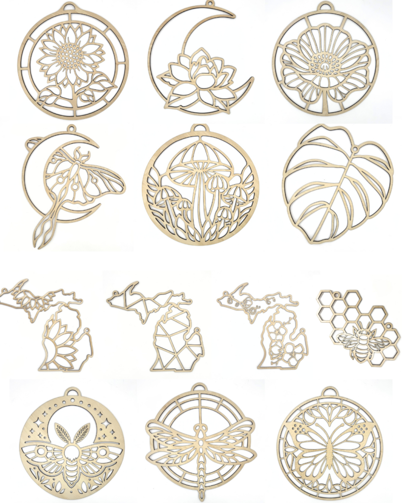 Laser-cut wooden ornaments featuring designs of flowers, leaves, insects, geometric animals, and honeycomb patterns, arranged in a grid on a white background. - Spruced Studio Upscale Workshop